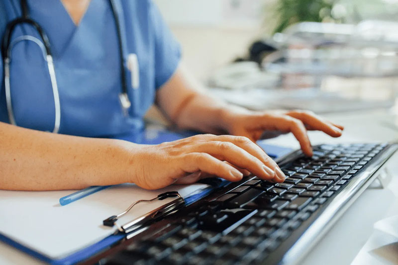 hands typing on a keyword