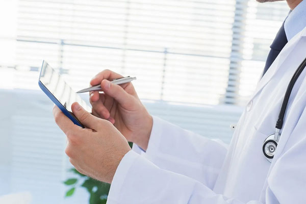 doctor using a tablet and pen