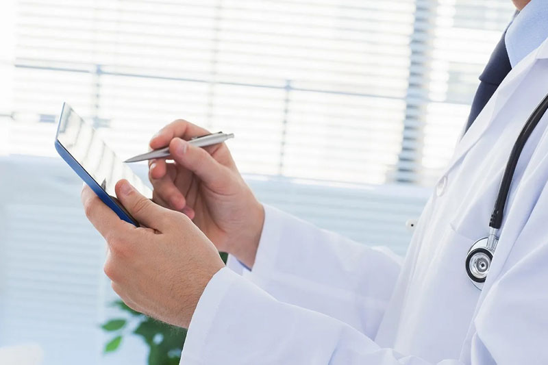 doctor using a tablet and pen