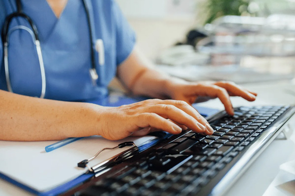 hands typing on a keyword